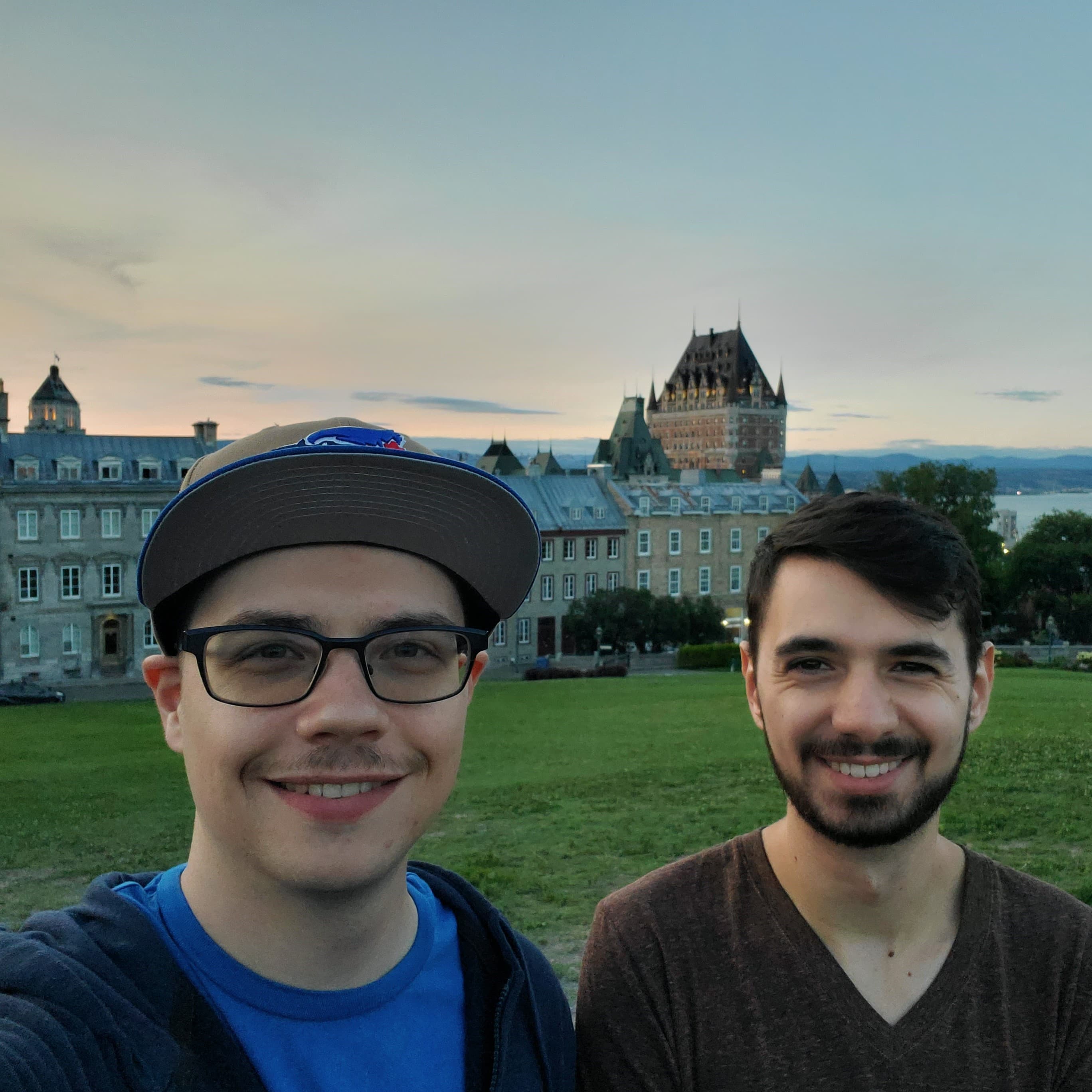 Paul and best friend Alex side by side with Fairmont Le Château Frontenac in Quebec City in the background